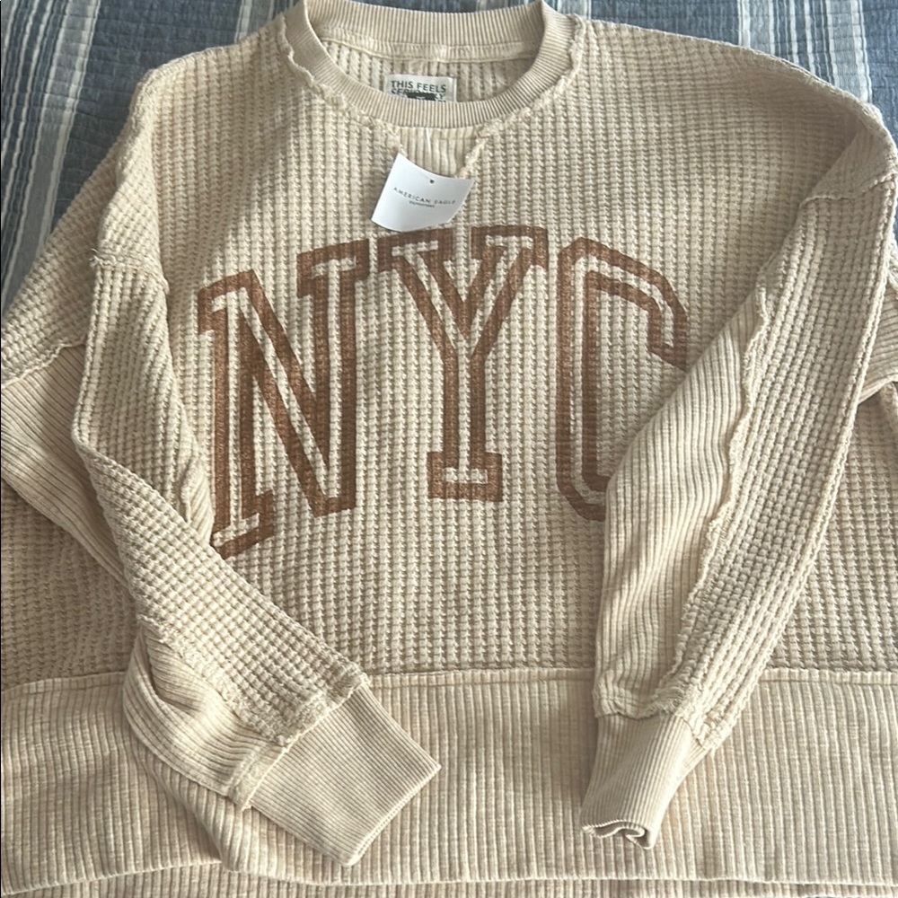 American Eagle Outfitters Beige Crewneck Sweater with NYC Design.